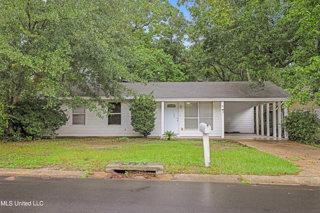 view of front of house with a front lawn and a carport