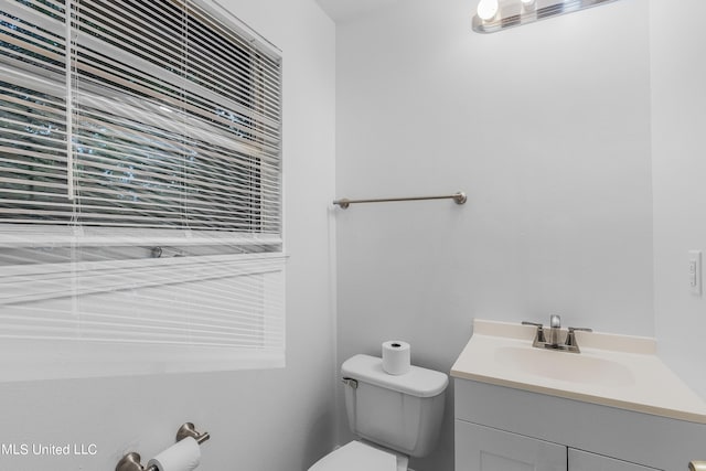 bathroom with toilet and vanity