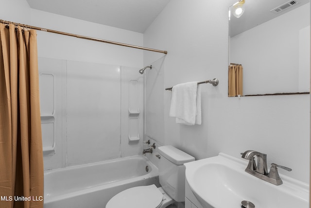 full bathroom with sink, shower / bath combo, and toilet