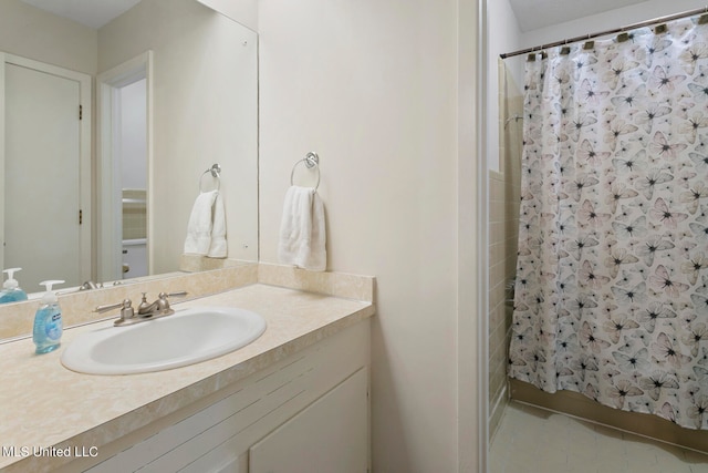 bathroom featuring vanity and curtained shower