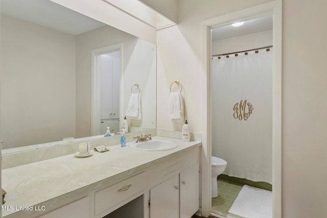 bathroom with vanity, toilet, and walk in shower