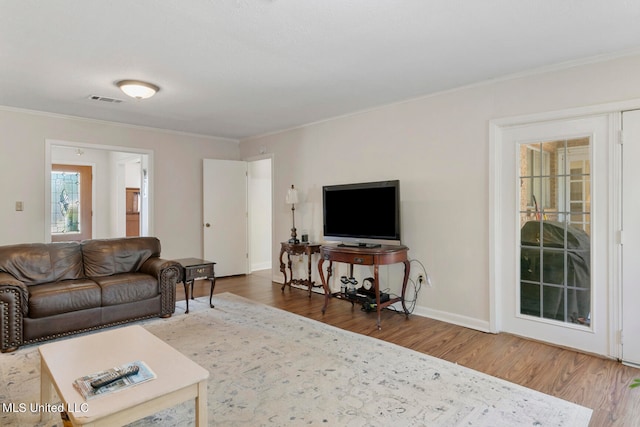 living room featuring ornamental molding and hardwood / wood-style floors