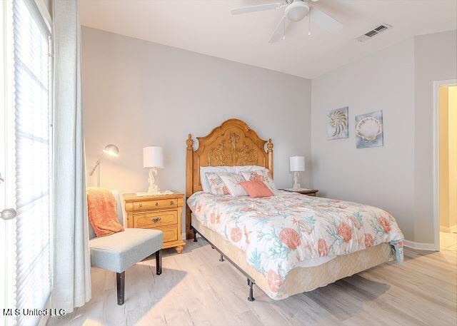 bedroom with ceiling fan and light wood-type flooring