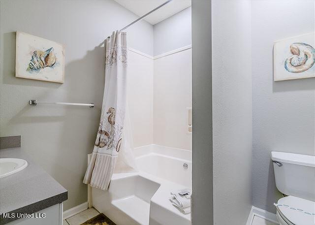 full bathroom featuring vanity, shower / bath combination with curtain, and toilet