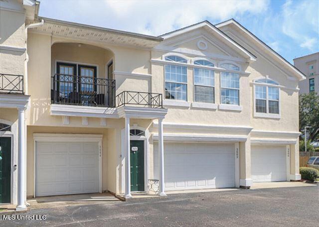 view of front of house with a garage and a balcony