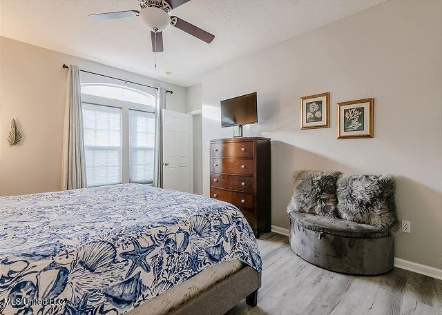 bedroom with light wood-type flooring and ceiling fan