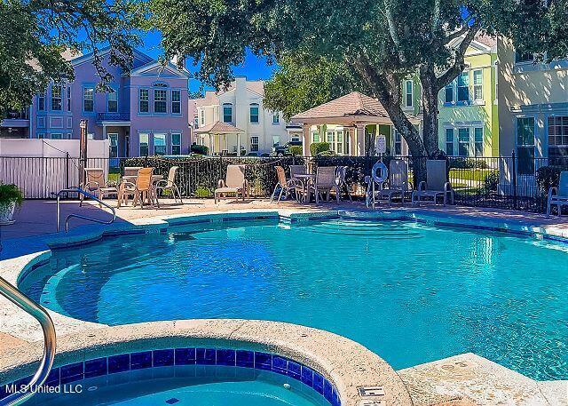 view of pool with a community hot tub