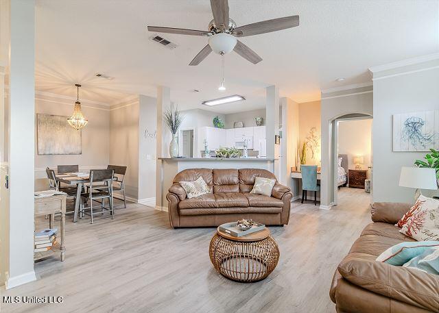 living room with ceiling fan, light hardwood / wood-style floors, and ornamental molding