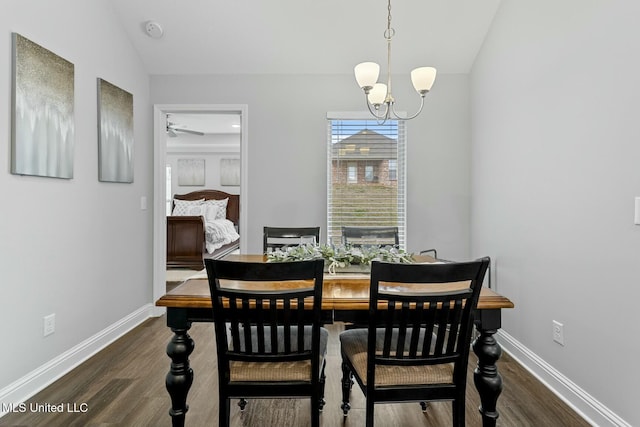 dining space with baseboards, lofted ceiling, and wood finished floors