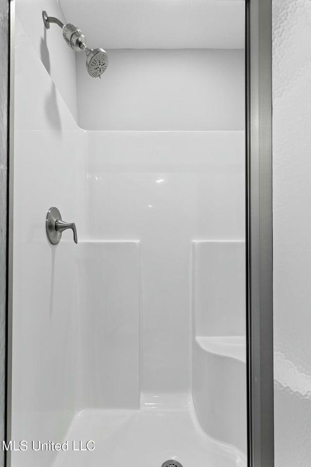 bathroom with a shower stall