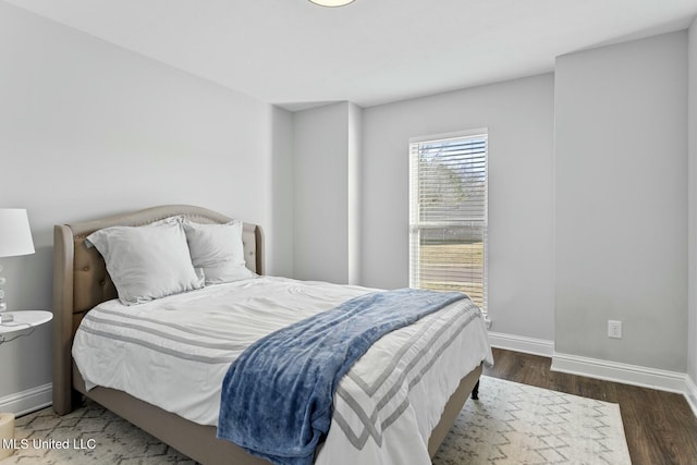 bedroom featuring wood finished floors and baseboards