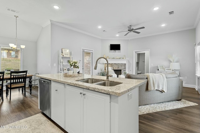 kitchen with visible vents, a sink, open floor plan, a fireplace, and stainless steel dishwasher