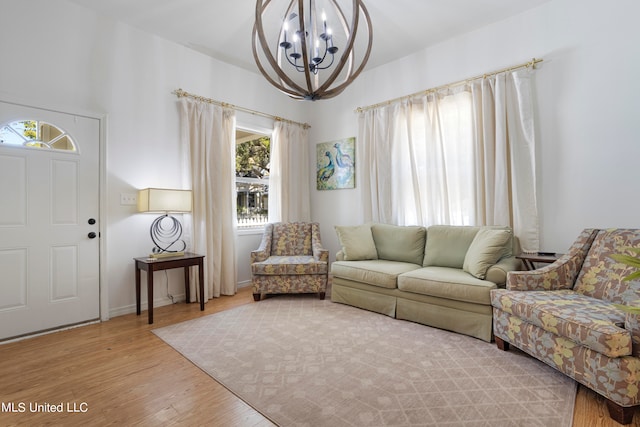 living room with light hardwood / wood-style flooring and an inviting chandelier