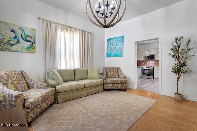 living room with light hardwood / wood-style flooring and an inviting chandelier