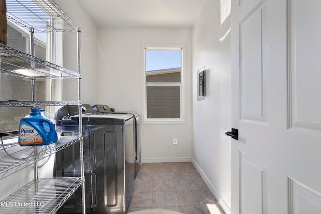 washroom with light tile patterned flooring and washing machine and clothes dryer