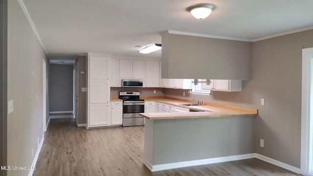 kitchen with stainless steel appliances, light wood-style flooring, ornamental molding, white cabinets, and light countertops