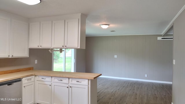 kitchen with dishwasher, baseboards, white cabinets, and a peninsula