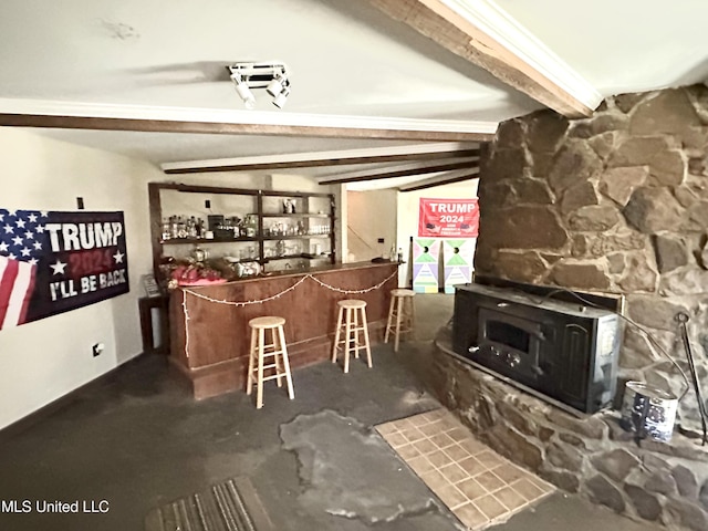 interior space featuring lofted ceiling with beams and a wood stove