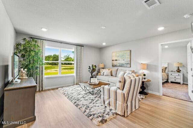 9624 Reserve Blvd, Biloxi, MS 39532 - living area with light wood-style floors, baseboards, and recessed lighting