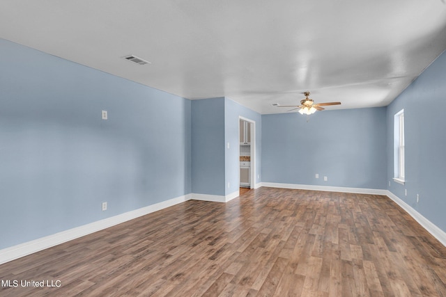 empty room with ceiling fan and hardwood / wood-style floors