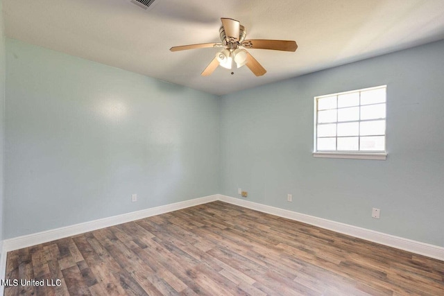 empty room with ceiling fan and hardwood / wood-style floors