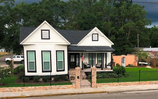 view of front of property with a front yard and covered porch