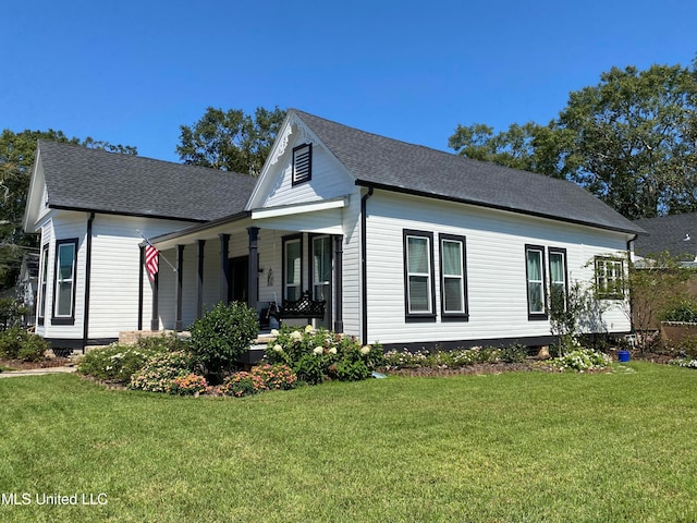 view of property exterior with a lawn and a porch