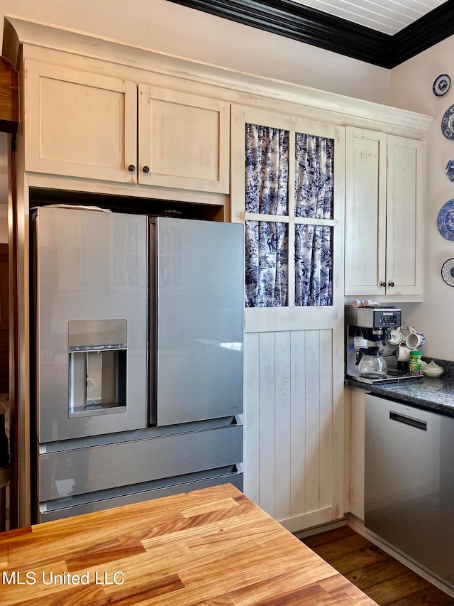 kitchen featuring butcher block countertops, crown molding, appliances with stainless steel finishes, and dark hardwood / wood-style flooring