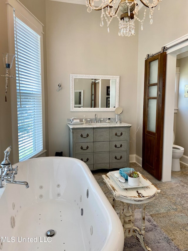 bathroom featuring vanity, toilet, a wealth of natural light, and a bath