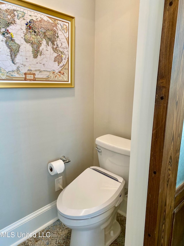 bathroom with toilet and tile patterned flooring