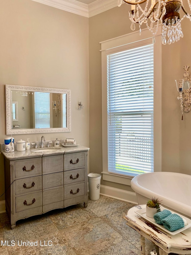 bathroom with vanity, a notable chandelier, ornamental molding, and a bathing tub