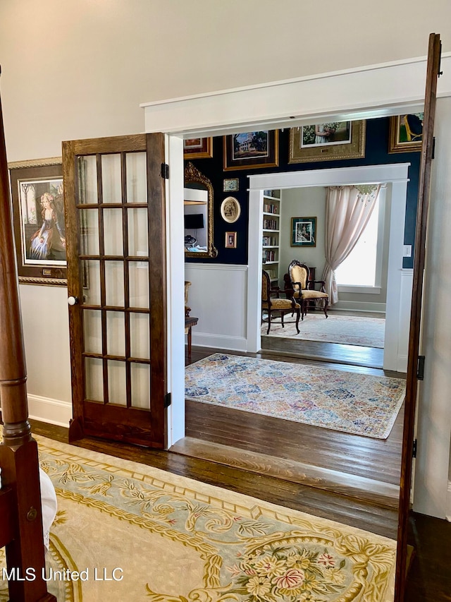 hallway with hardwood / wood-style floors