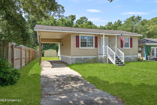 view of front of property with a front yard and a shed