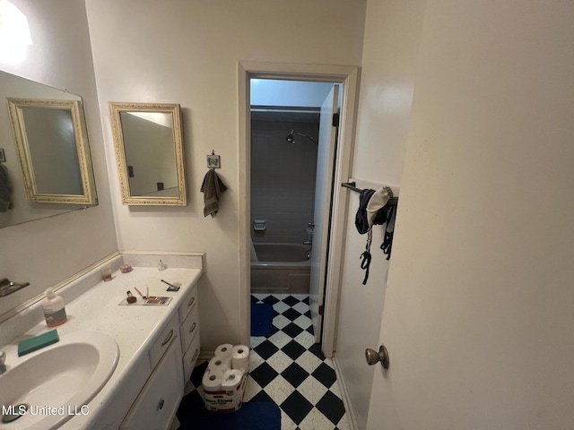 bathroom featuring vanity and  shower combination