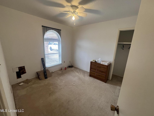 unfurnished bedroom featuring light carpet and ceiling fan