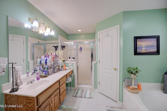 full bath with a garden tub, a stall shower, vanity, a textured ceiling, and tile patterned flooring