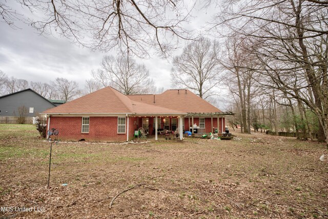 rear view of house featuring a patio area and brick siding