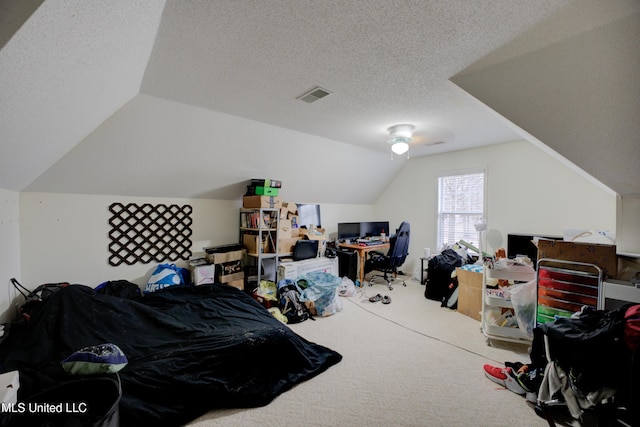 carpeted bedroom featuring lofted ceiling, visible vents, and a textured ceiling