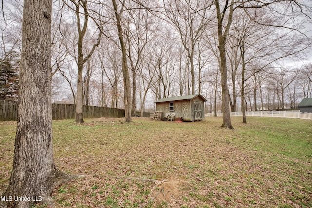 view of yard featuring an outbuilding, a shed, and a fenced backyard