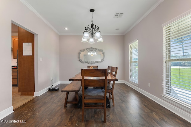 dining space with ornamental molding, a chandelier, and dark hardwood / wood-style floors