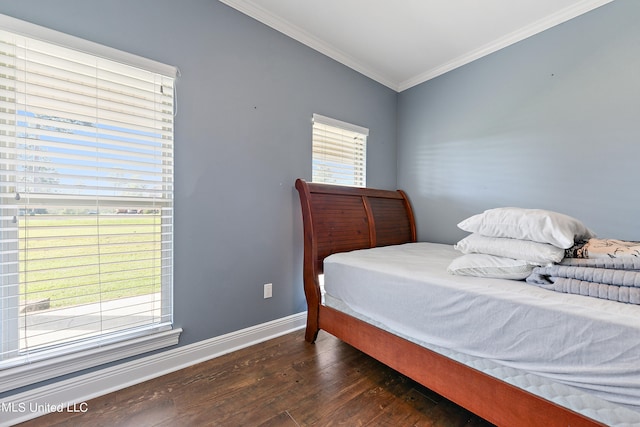 bedroom featuring ornamental molding, dark wood-type flooring, and multiple windows