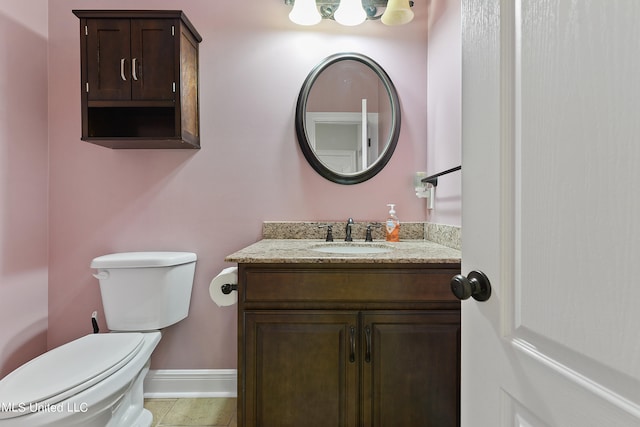 bathroom featuring toilet, vanity, and tile patterned floors