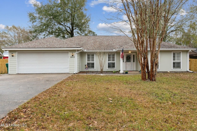 ranch-style house with a garage and a front lawn