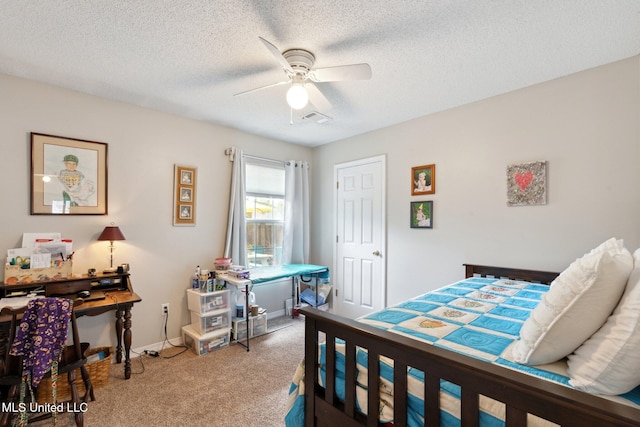 carpeted bedroom with ceiling fan and a textured ceiling