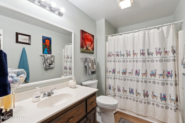 bathroom with hardwood / wood-style floors, vanity, and toilet