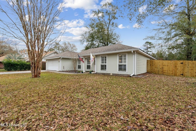 ranch-style house featuring a garage and a front lawn