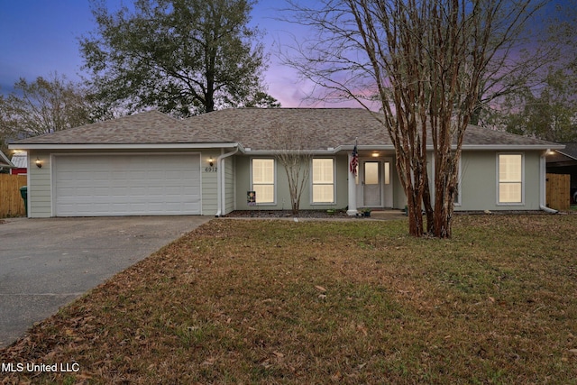 ranch-style home with a lawn and a garage