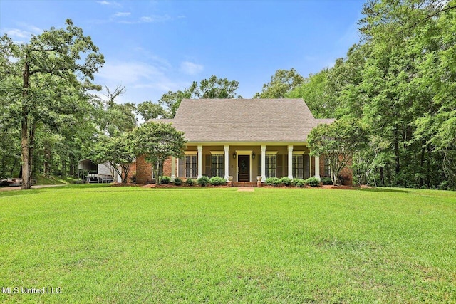 1507 W Flowers Rd, Terry, MS 39170 - view of front of property with covered porch, a front yard, and brick siding