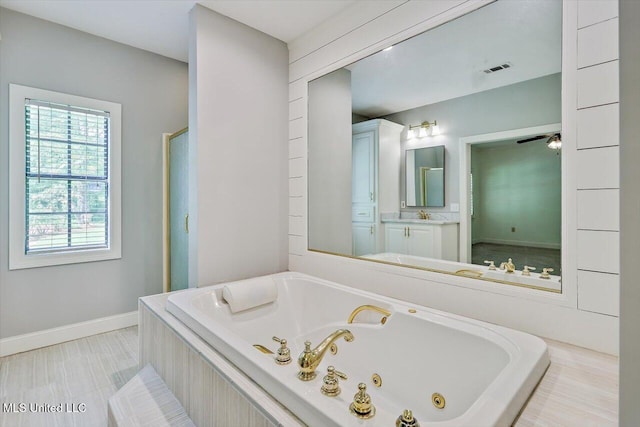1507 W Flowers Rd, Terry, MS 39170 - full bath with a tub with jets, vanity, and baseboards
