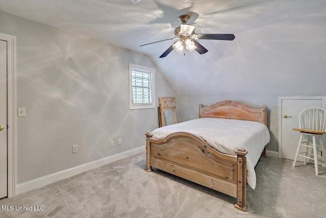 1507 W Flowers Rd, Terry, MS 39170 - carpeted bedroom with vaulted ceiling, baseboards, a ceiling fan, and a textured ceiling